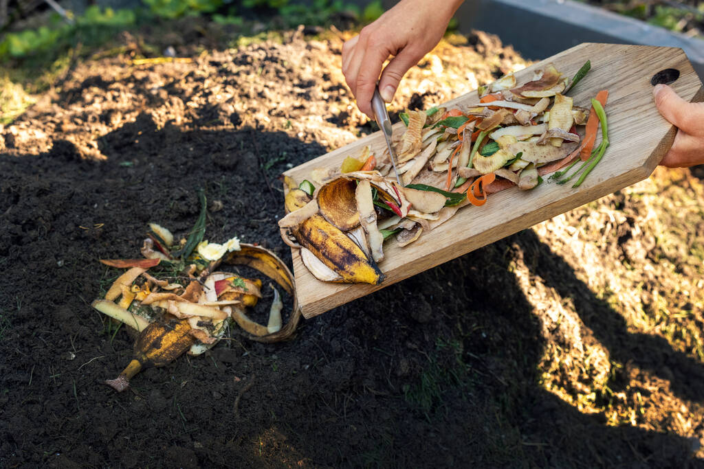 Mixing Food Leftovers In Compost Pit